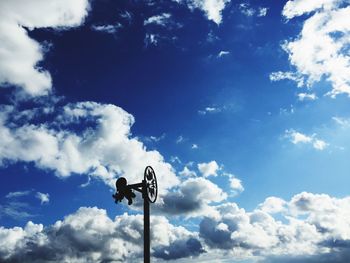 Low angle view of street light against cloudy sky