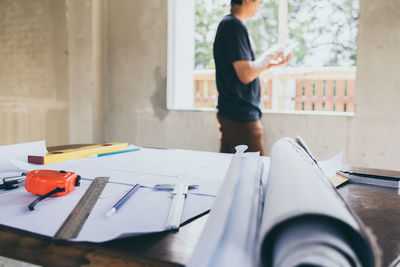 Midsection of woman reading book on table