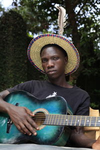 Portrait of man playing guitar