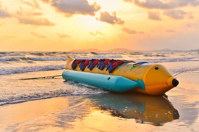 Banana boat on the beach with golden hour and reflecting on the beach