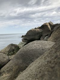 Rocks on beach against sky