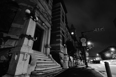 No parking sign on sidewalk in city at night