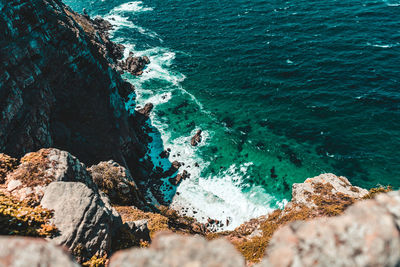 High angle view of cliff by beach