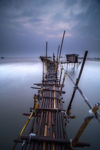 Cranes against sky in sea