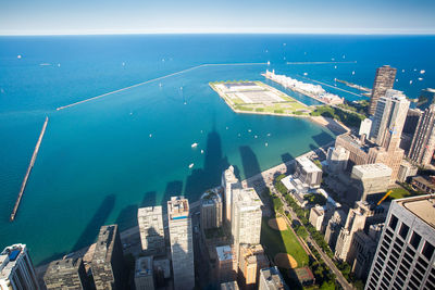 High angle view of buildings by sea against sky