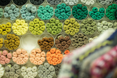 Colorful ball of wool in containers for sale
