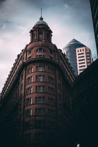 Low angle view of building against cloudy sky