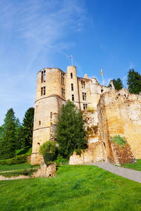 Low angle view of historical building against blue sky