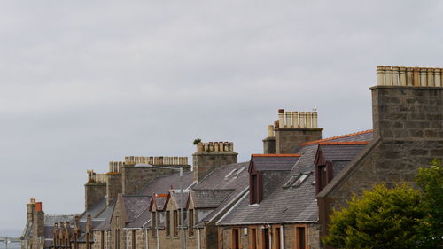 Traditional roofs and chimneys of scottish house, invergordon