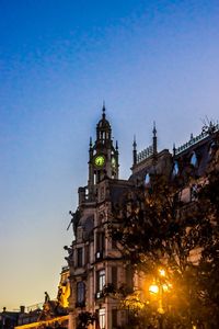 Illuminated buildings against blue sky