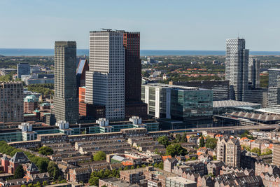 Aerial view of buildings in city against sky