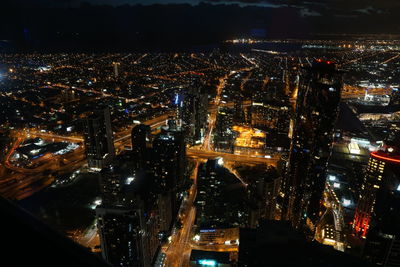 Aerial view of city lit up at night