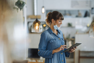 Full length of woman using mobile phone