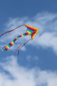 Low angle view of kite flying against sky