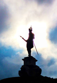 Low angle view of statue against cloudy sky