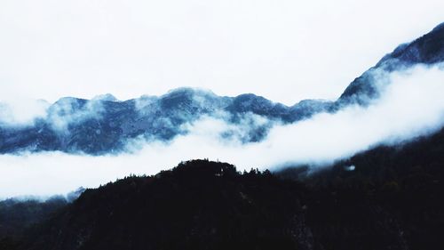 Scenic view of mountains in foggy weather