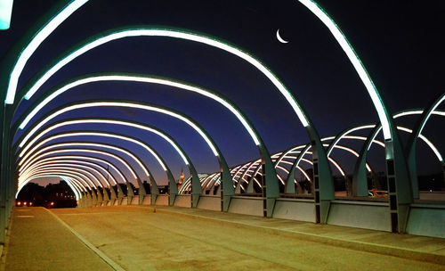 Illuminated corridor of building at night