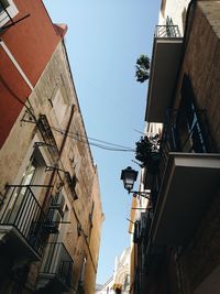 Low angle view of buildings in town against sky