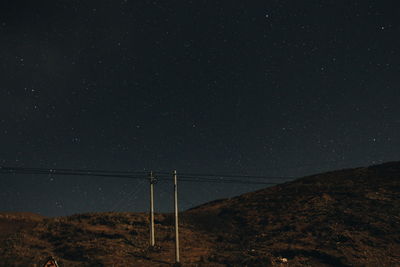 Scenic view of landscape against star field at night