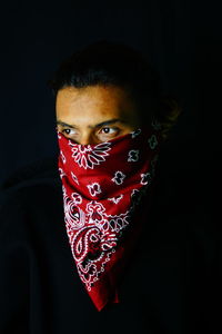 Portrait of woman against black background