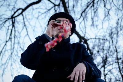 Low angle view of a man holding streamer