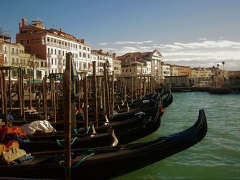 Gondolas moored on grand canal in city