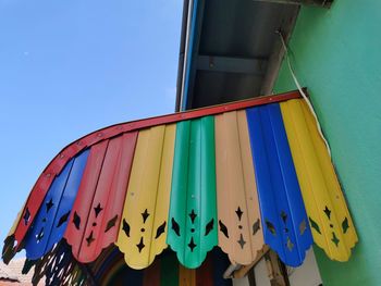 Low angle view of flags against blue sky