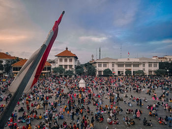 People on street against buildings in city