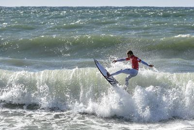 People surfing in sea