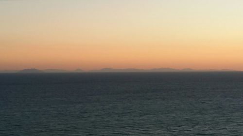 Scenic view of sea against clear sky during sunset