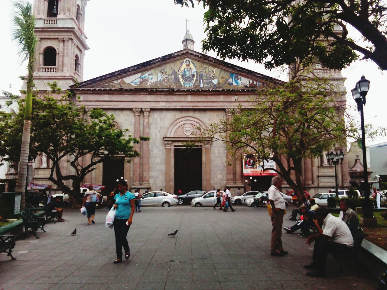 architecture, built structure, building exterior, religion, tree, large group of people, outdoors, place of worship, spirituality, day, real people, men, women, sky, people