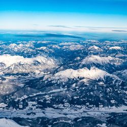 Aerial view of snowcapped mountains against sky