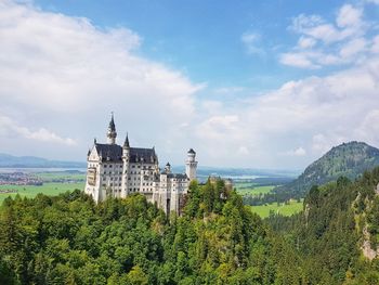 Panoramic view of trees and buildings against sky