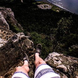 Low section of man standing on mountain