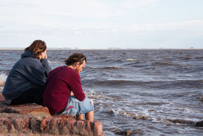 Couple sitting near the sea