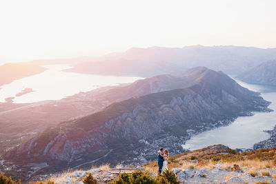 Man standing on mountain against sky