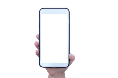 Close-up of hand holding mobile phone against white background