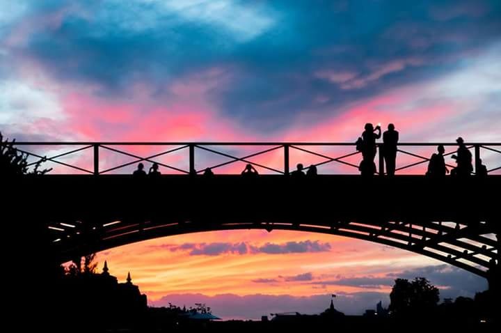 SILHOUETTE OF BRIDGE OVER RIVER