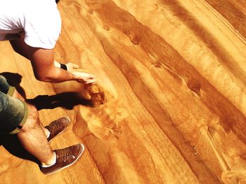 Low section of man skateboarding on floor