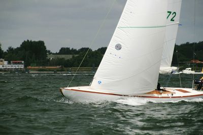 Sailboat sailing in sea against sky