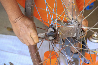 Close-up of man working on metal