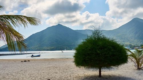 Scenic view of sea and mountains against sky