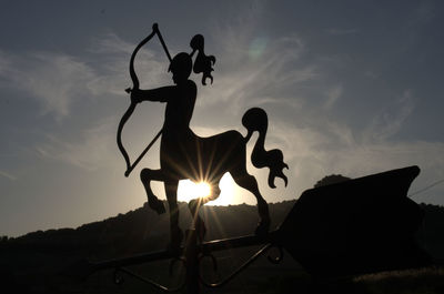 Silhouette man standing against sky during sunset