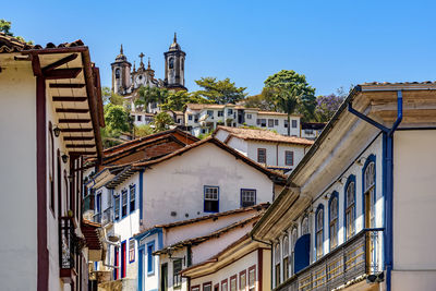 Low angle view of buildings in town against sky