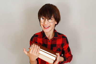 Portrait of smiling young woman against white background