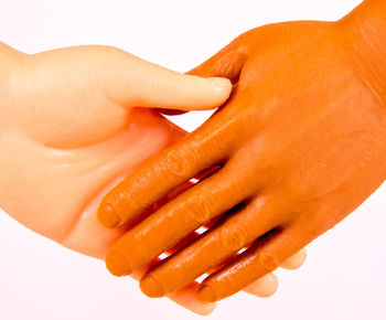 Close-up of woman hand over white background