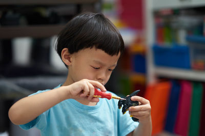 Cute boy playing with toy