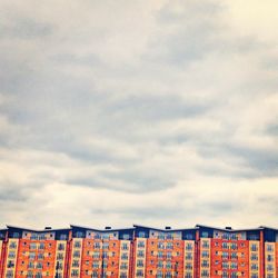 Low angle view of building against cloudy sky