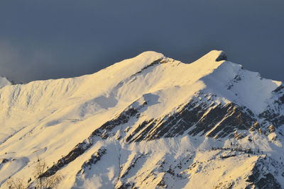 Aerial view of snowcapped mountains against sky