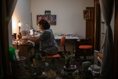 Woman sitting on table at home